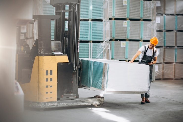 young-man-working-warehouse-with-boxes_1303-16632